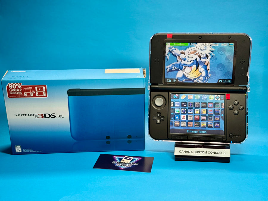 A Nintendo 3DS XL — Blue/Black | Fully Modded sits open with a Pokémon wallpaper, alongside its original box and a Canada Custom Consoles card, all displayed on a blue background.