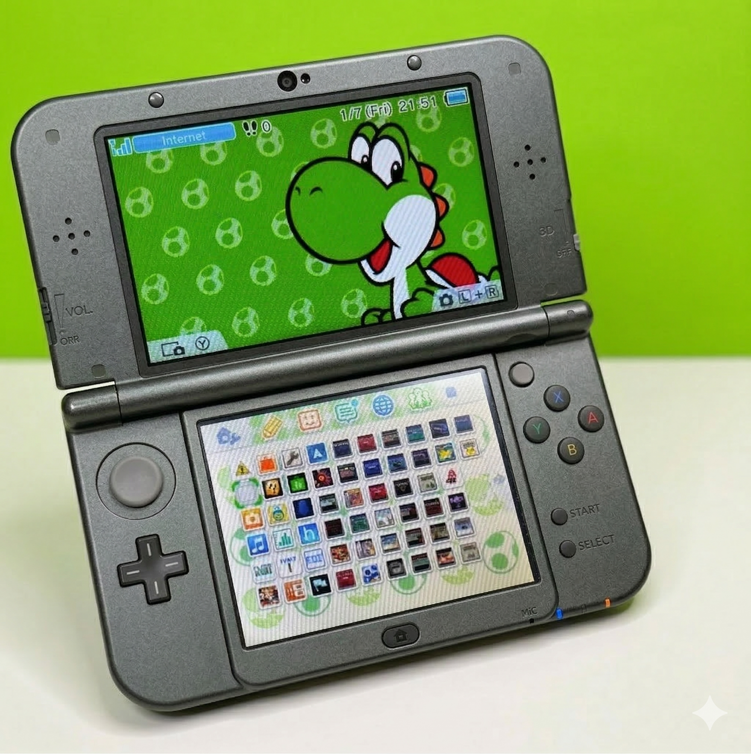 A black Nintendo 3DS XL is open, displaying a Yoshi-themed background on the top screen and a grid of app icons on the bottom screen, set against a bright green background.