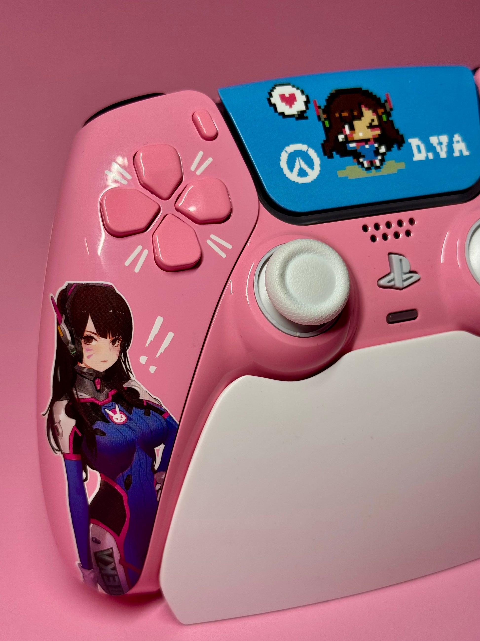 The D.Va Overwatch Custom PS5 Controller | Hall Effect Sticks | Pink features Overwatch D.Va designs, an illustrated sticker, pixel art touchpad cover, and precision Hall Effect analog sticks—all on a vibrant pink background.