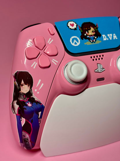 The D.Va Overwatch Custom PS5 Controller | Hall Effect Sticks | Pink features Overwatch D.Va designs, an illustrated sticker, pixel art touchpad cover, and precision Hall Effect analog sticks—all on a vibrant pink background.
