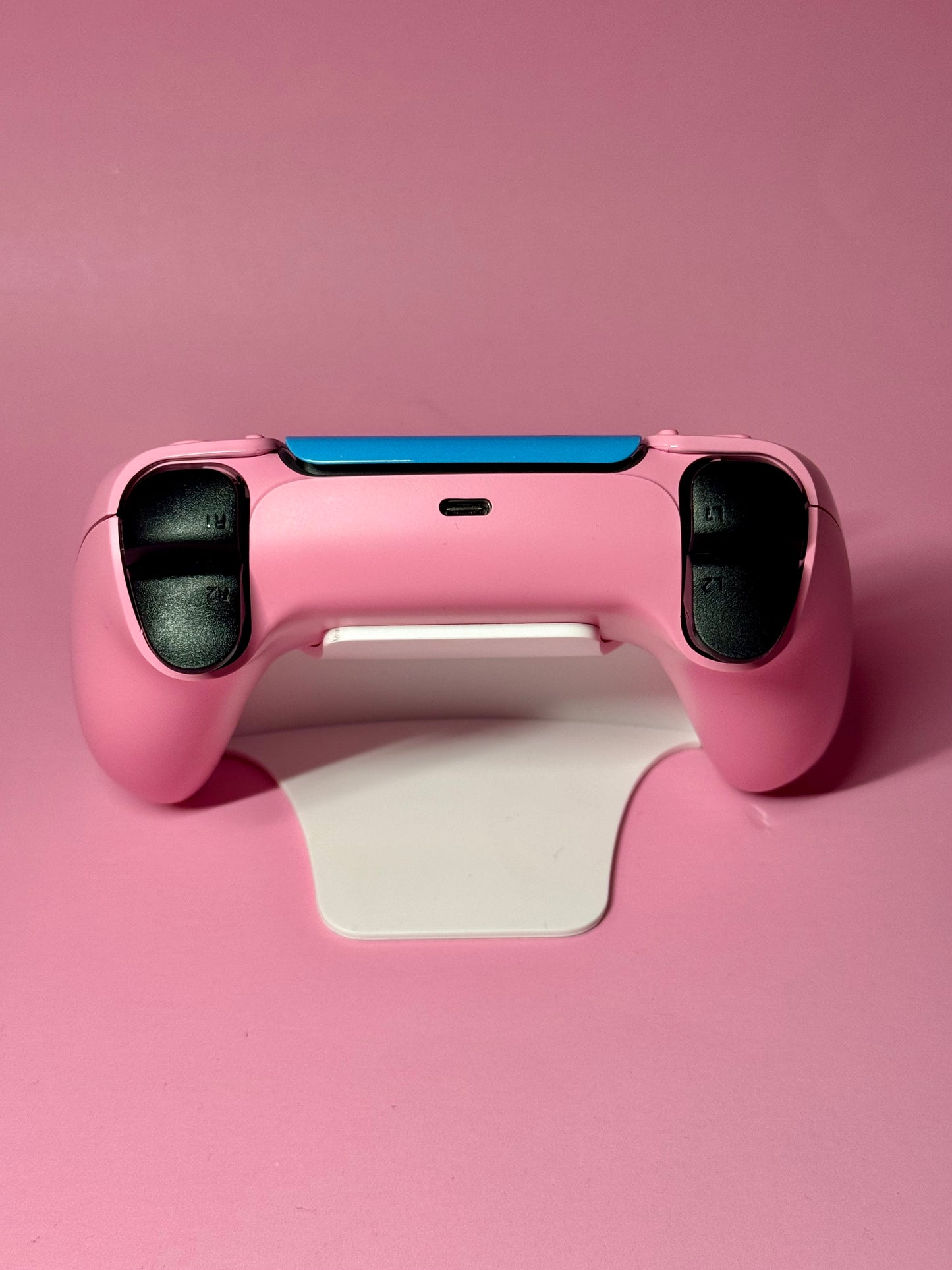 The D.Va Overwatch Custom PS5 Controller with Hall Effect sticks features a pink design with black buttons and is shown on a white stand against a pink background.