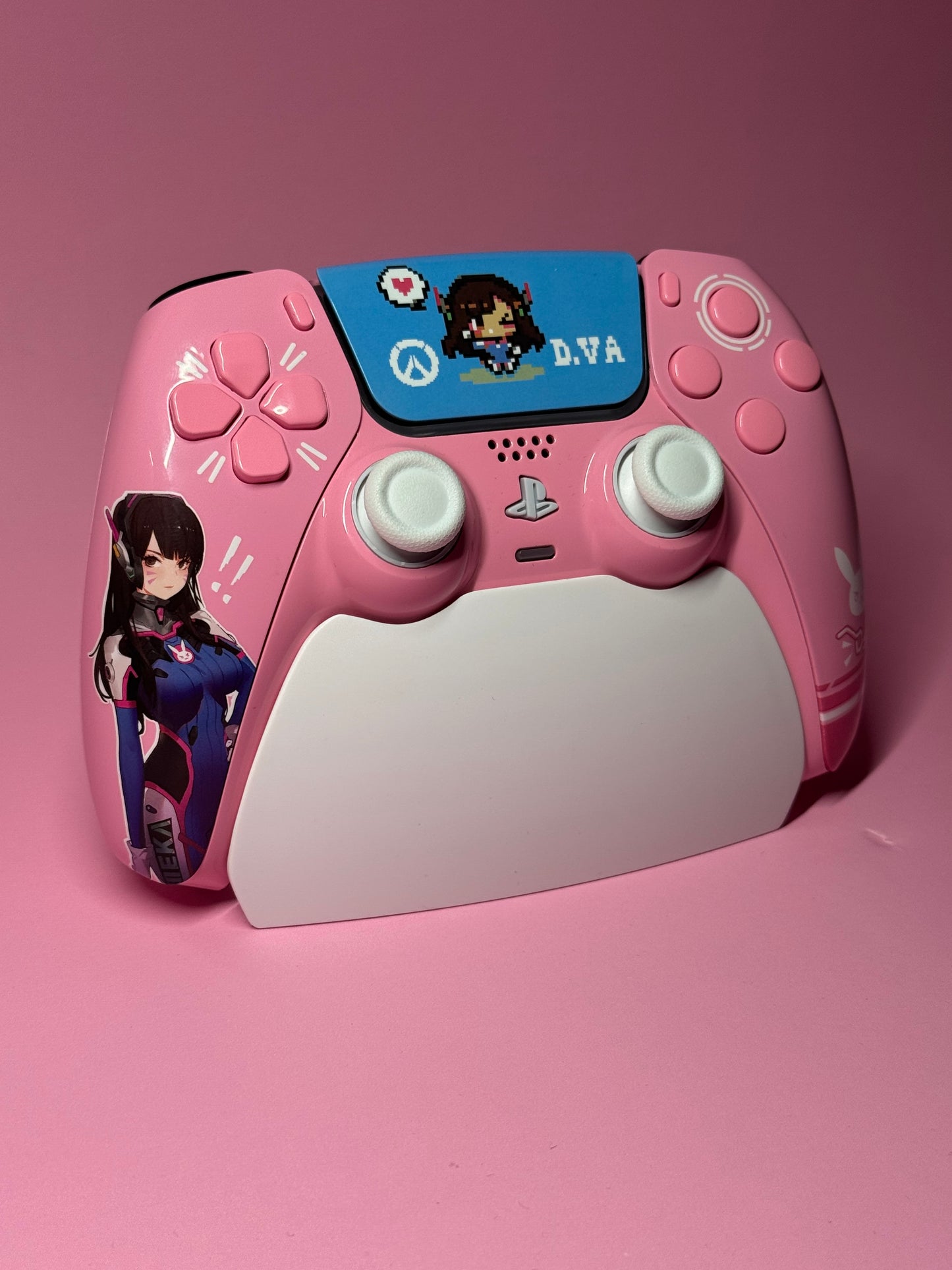 The D.Va Overwatch Custom PS5 Controller in pink features themed decals, a D.Va illustration and pixel art on a blue background, with Hall Effect sticks for smooth, drift-free gaming.