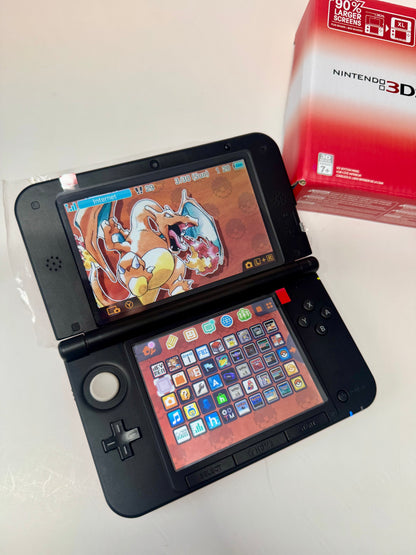 A refurbished Nintendo 3DS XL — Red/Black is open on a white surface, showing a Charizard-themed home screen with colorful app icons. Part of the red Nintendo 3DS XL box is visible in the upper right corner. Fully modded.