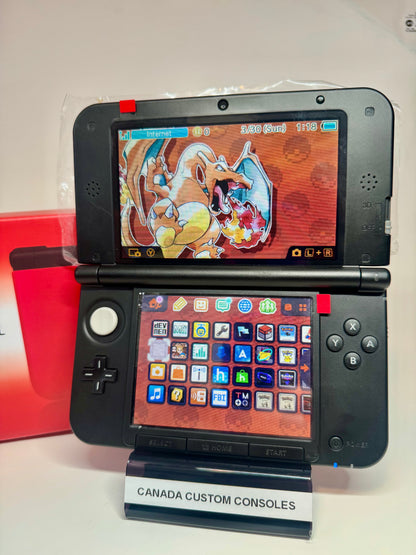 A refurbished Nintendo 3DS XL — Red/Black | Fully Modded is displayed open on a stand labeled CANADA CUSTOM CONSOLES. The top screen features Charizard art, and the bottom shows colorful app icons on this unique console.