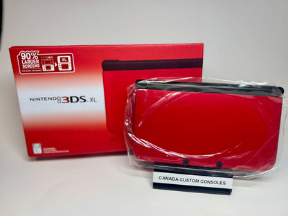 A refurbished Nintendo 3DS XL — Red/Black | Fully Modded is shown in plastic in front of its box, with a CANADA CUSTOM CONSOLES sign displayed before the retro handheld.