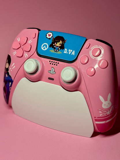 The D.Va Overwatch Custom PS5 Controller | Hall Effect Sticks | Pink features cartoon D.Va and bunny logo details on a matching pink surface, with a touchpad showcasing pixel art D.Va and a heart for added charm.
