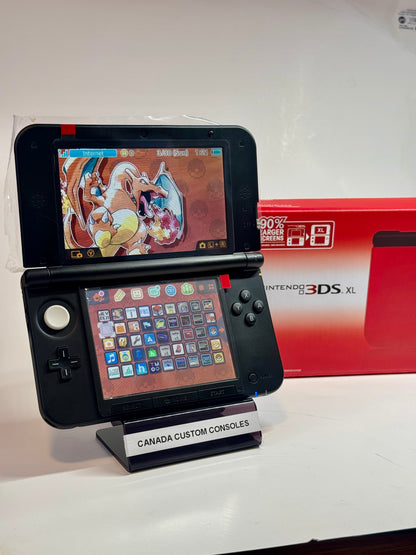 A refurbished Nintendo 3DS XL (Red/Black), fully modded with a custom Pokémon Charizard theme and colorful app icons, is displayed. The red box and a stand reading "CANADA CUSTOM CONSOLES" highlight this retro gaming console.