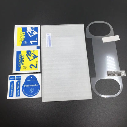 The PS Vita 1000 Tempered Glass Screen Protector | OLED Display Protection kit includes a clear glass protector, cleaning wipes labeled 1 and 2, dust absorber, guide stickers, and protective packaging on a black surface.