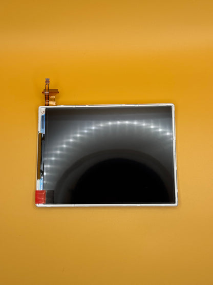 The NEW Nintendo 3DS XL/LL Lower Screen Replacement, featuring a black surface and visible connectors, is shown on a solid orange background—ideal for replacing the lower screen of your device.