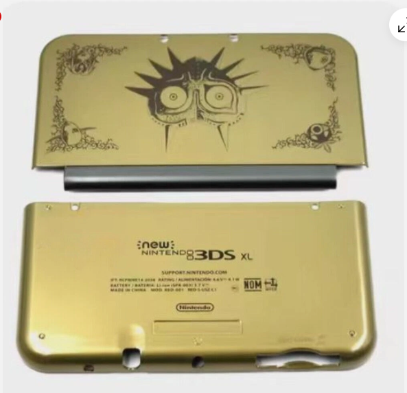 Gold New Nintendo 3DS XL console with Majora's Mask design on a white background