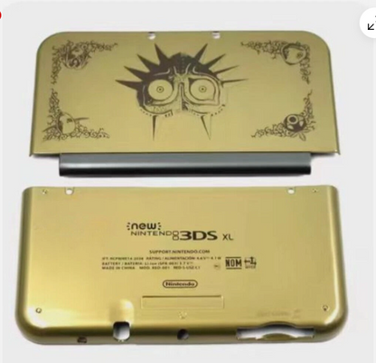Gold New Nintendo 3DS XL console with Majora's Mask design on a white background