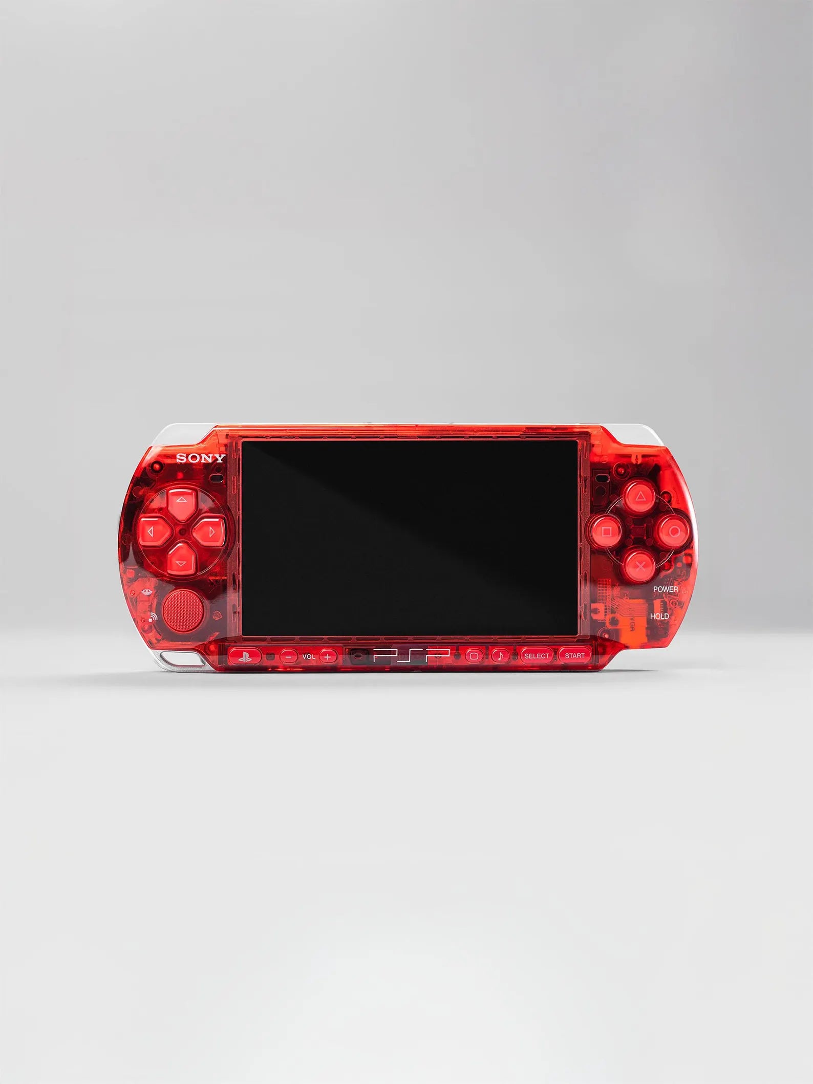 A Seller PSP 3000 (128GB) — 1000+ Games in a Crimson Red Transparent Shell, black screen centered on a light gray background—gaming in style with over 1000 titles.