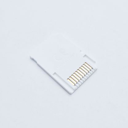 A white SD2Vita 5.0 MicroSD Adapter for PS Vita with gold connector pins rests on a plain white background, featuring faint "Made in China" text. Ideal for expanding storage using a MicroSD card on your PS Vita system.